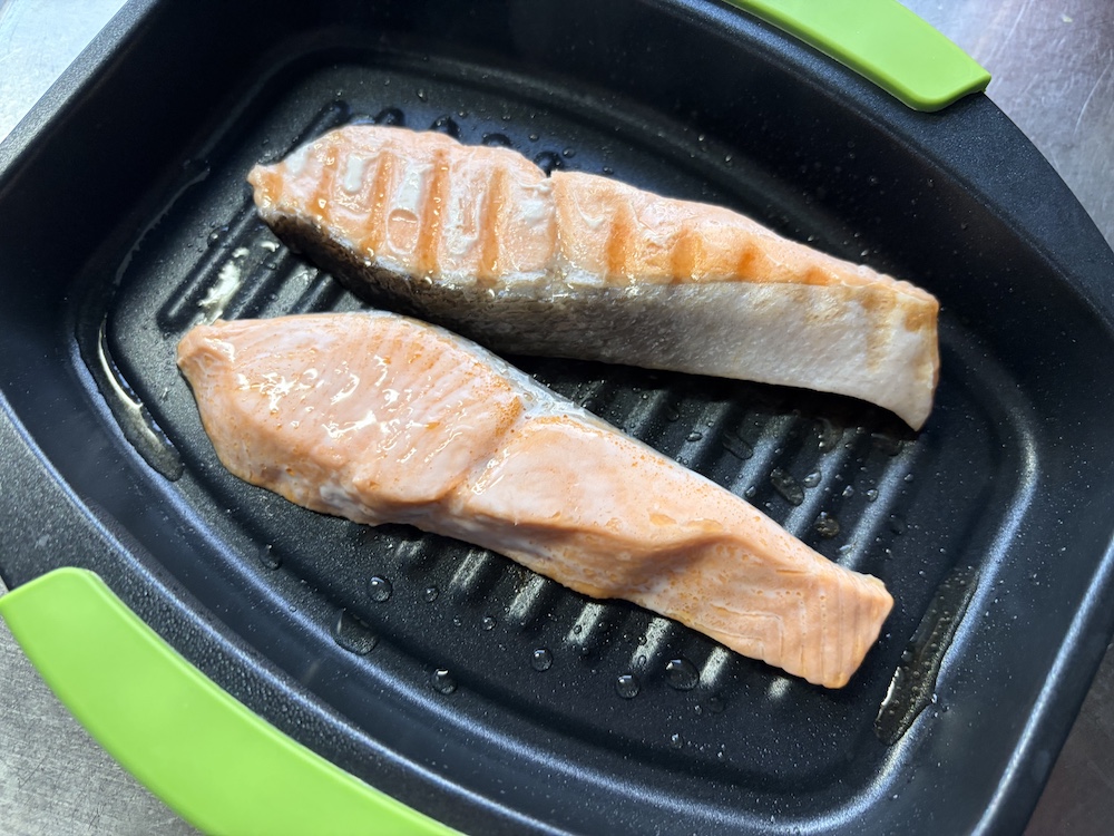 レンジで焼ケールで調理する途中のシャケの切り身の写真